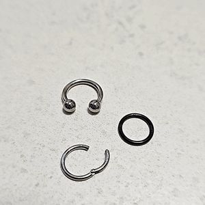 3 nose rings, 2 snap into place and 1 U-shaped ring